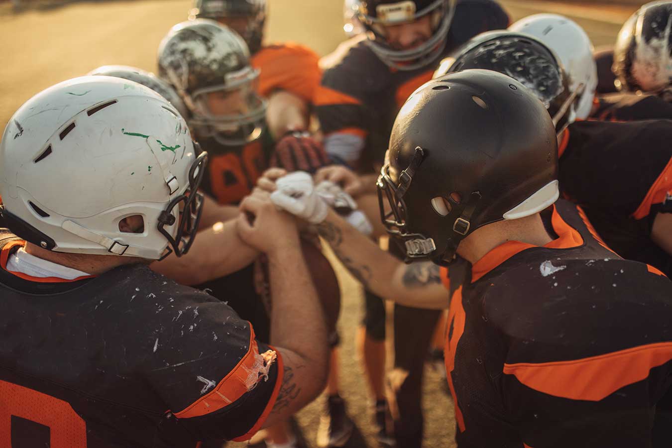 American Football Players Huddling During Time Out Football players in a huddle