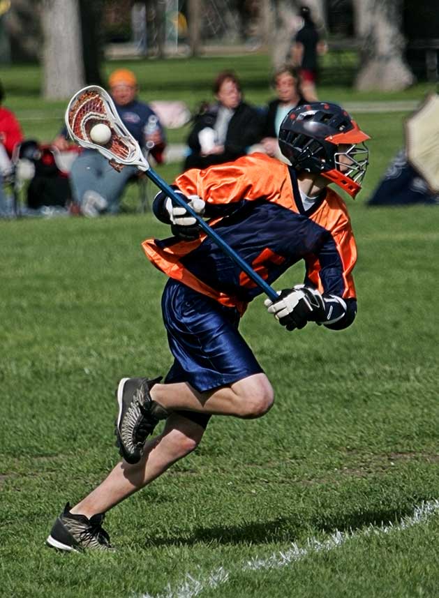 istockphoto-93164399-crop Lacrosse player in orange and blue uniform